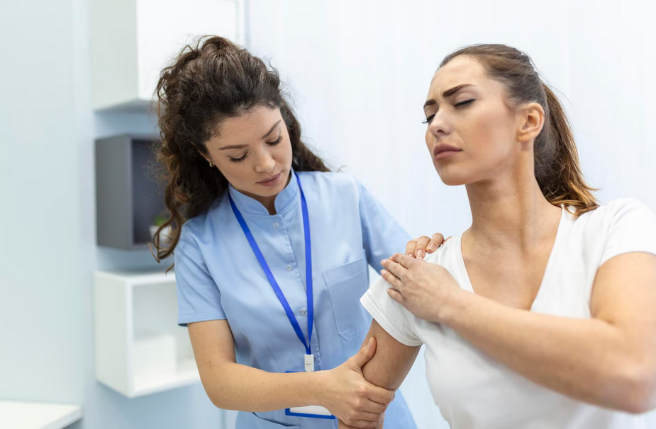 Physiotherapist supporting shoulder movement